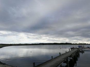 Pier over lake against sky
