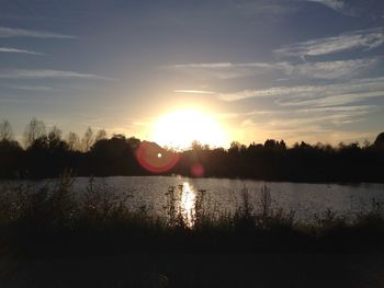 Scenic view of river at sunset