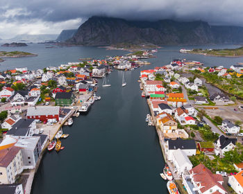 High angle view of buildings by sea against sky