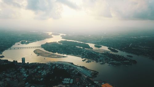 Aerial view of sea and buildings against sky