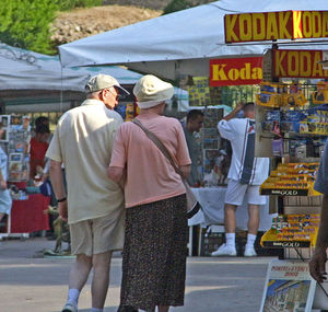 Rear view of people at market stall in city