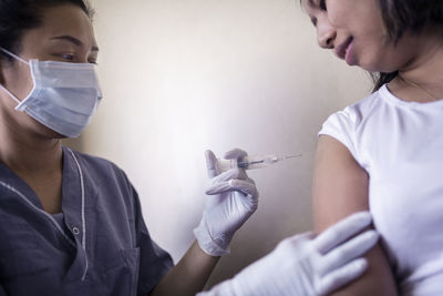 Woman receiving injection in her arm