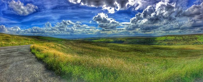 Scenic view of landscape against cloudy sky