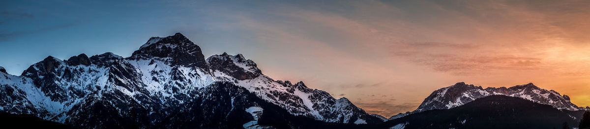 Panoramic view of tree mountains against sky during sunset
