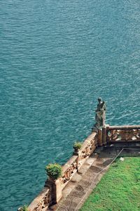 High angle view of lizard on wall by sea