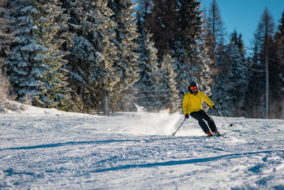 Man skiing on snow covered field