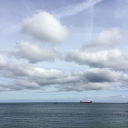 Scenic view of calm sea against cloudy sky