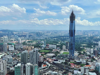 High angle view of modern buildings in city against sky