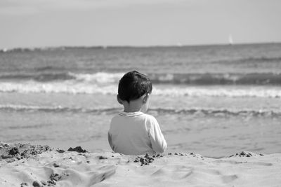 Rear view of boy on beach