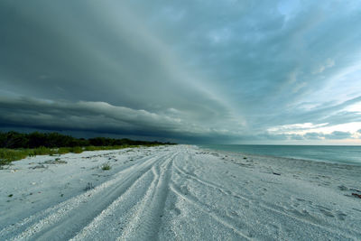 Storm clouds forming at dusk in empty beach in celestún, yucatán, méxico.