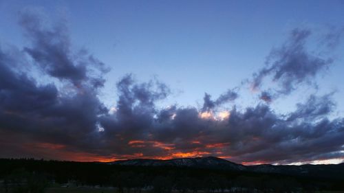 Scenic view of silhouette landscape against sky at sunset