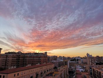 High angle view of buildings against sky during sunset