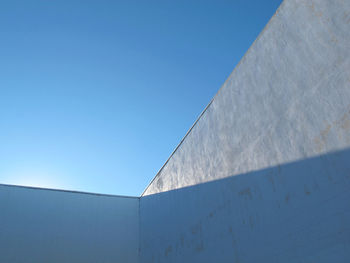 Low angle view of built structure against clear blue sky