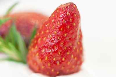 Close-up of strawberry over white background