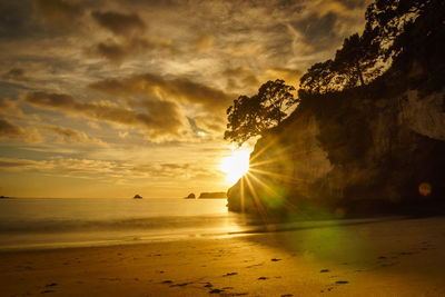Sun shining over sea during sunset
