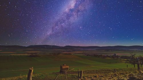 Scenic view of field against sky at night