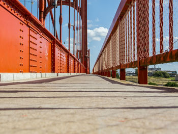 Surface level of bridge against sky in city