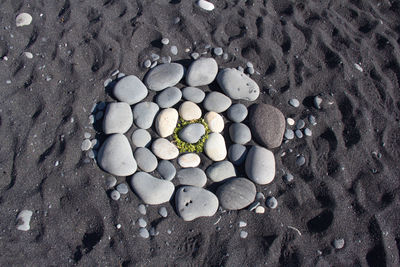 High angle view of pebbles on sand