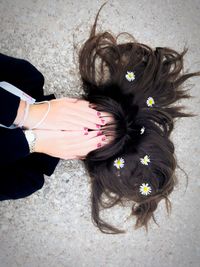 High angle view of woman with flowers in hair