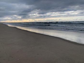 Scenic view of beach against sky during sunset