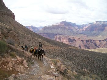 People riding horse in mountains