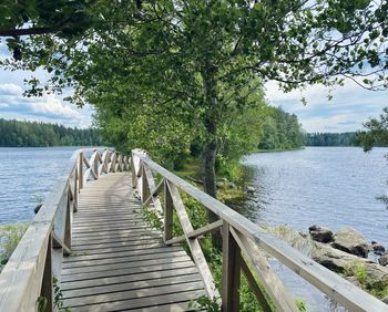 Wooden pier over lake against sky