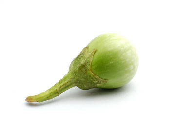 Close-up of green fruit against white background