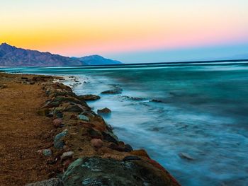 Scenic view of sea against sky at sunset