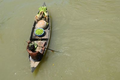 High angle view of people rowing boat in river