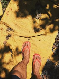 Low section of woman standing on sand