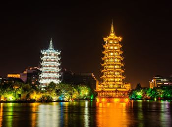 Illuminated building against sky at night