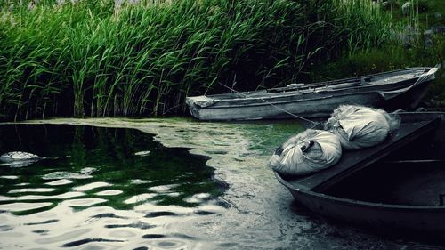 Abandoned boat moored in lake