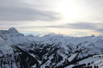 Scenic view of snow covered mountains against sky