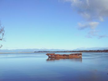 Scenic view of lake against blue sky