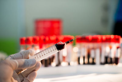 Cropped hand of doctor holding syringe at hospital