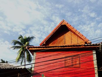 Low angle view of building against cloudy sky