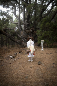 Rear view of woman standing in park