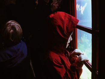 Rear view of people with daughter against sky