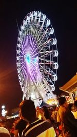 Low angle view of ferris wheel against sky at night