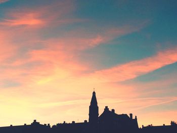 Silhouette of built structure at sunset