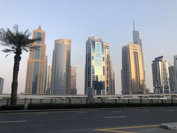 Modern buildings in city against clear sky