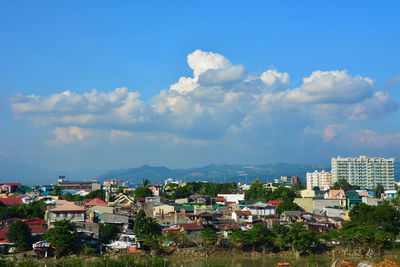 Cityscape against cloudy sky