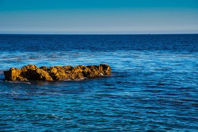 Scenic view of sea against blue sky