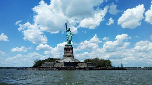 Statue of liberty against cloudy sky