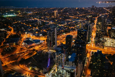 High angle view of city lit up at night