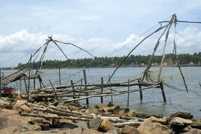 Sailboats on sea shore against sky