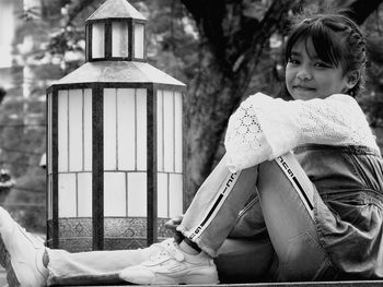 Rear view of girl standing against trees