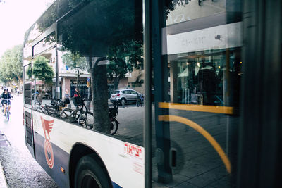 Cars on street seen through glass window