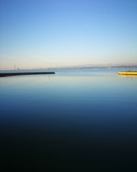 Scenic view of sea against clear blue sky