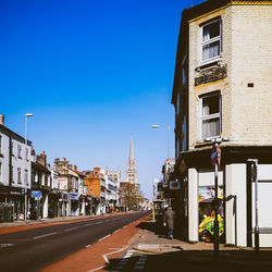 Street amidst buildings against sky